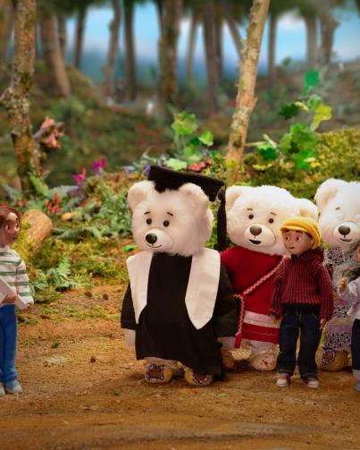 Still from Spirit Bear movie showing Spirit Bear graduating Still from Spirit Bear movie showing Spirit Bear graduating